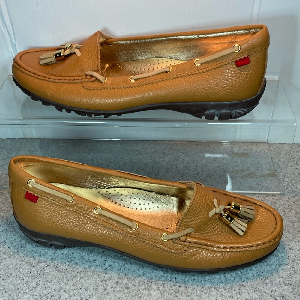 9.5 Marc Joseph thick leather driving moccasins with gold accents and tassels.